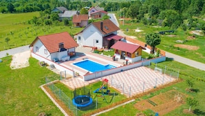 A residential area with houses, a swimming pool, and a playground. - Stunning home in Gospic with sauna (Gospic)