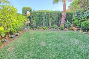 A well-maintained garden with a variety of plants and a neatly trimmed lawn.