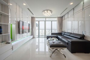Superior Apartment, 4 Bedrooms | Living area | 55-inch Smart TV with digital channels, TV - Vinhomes Luxury - Kelvin's Home (Ho Chi Minh City)