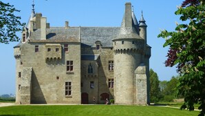 A large stone castle with multiple towers and a central courtyard.