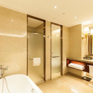 A modern bathroom with a glass-enclosed shower, a bathtub, and a vanity with a mirror and towel rack. - Jinyi Jinglan Hotel (Jinhua)