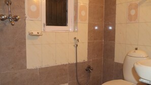 A bathroom with a toilet, a shower, and a window. - Great Nepal Bed & Breakfast (Lalitpur)
