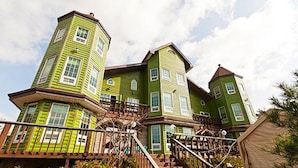 A large, multi-story house with a prominent tower and a wrap-around porch. - Beach Terrace Pension Taean (Taean)
