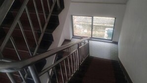 A staircase with metal railings leading to a landing. - Natural Lodge Homestay (Guilin)