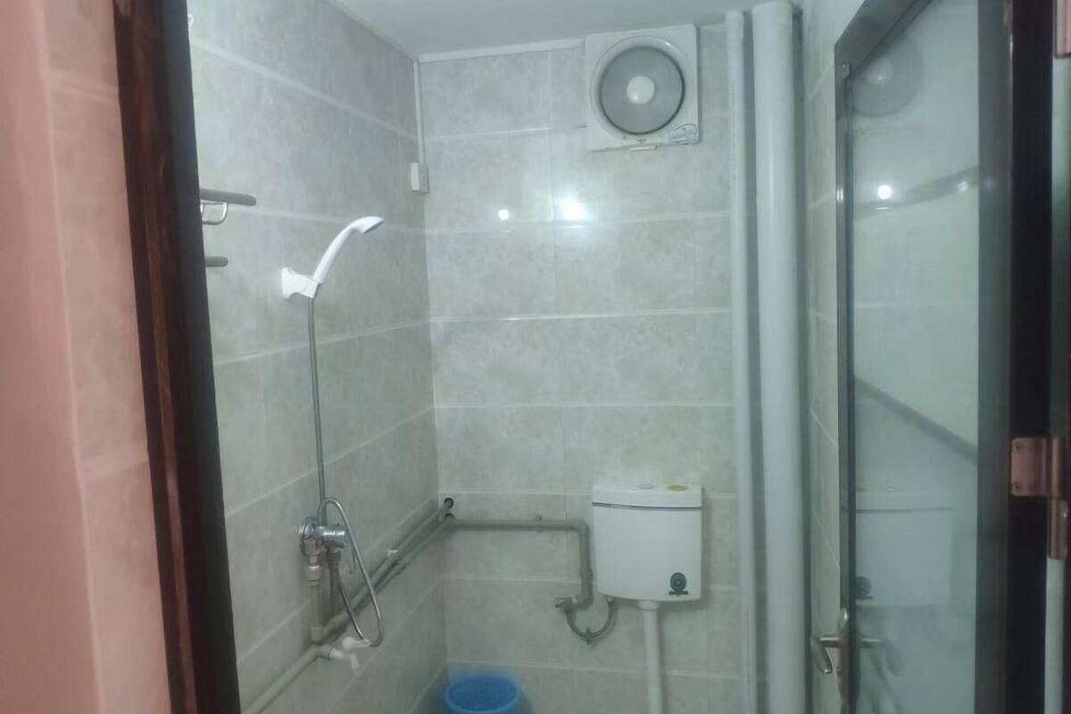 Shower, hair dryer, slippers, towels