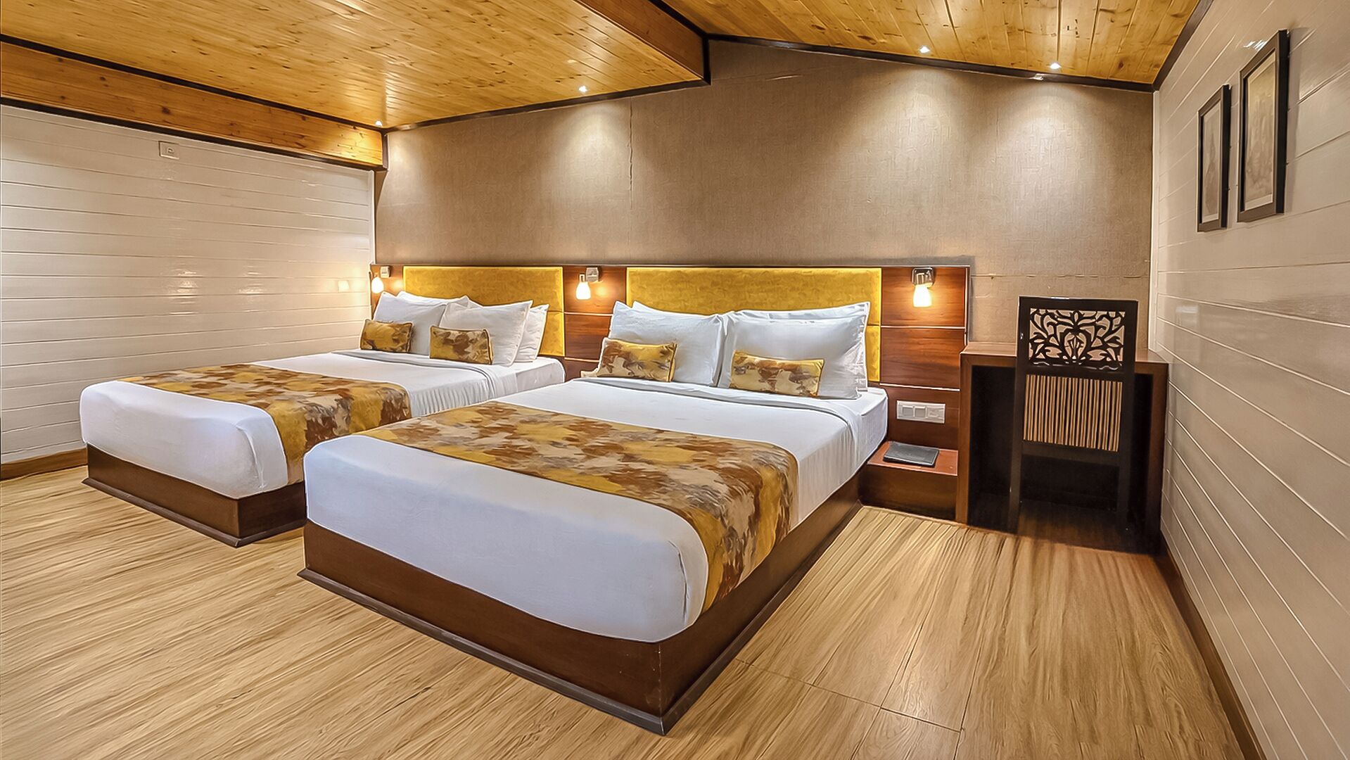 A hotel room with two beds, wooden flooring, and a modern design.