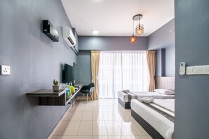 Relax in a serene space with a large bed, flat-screen TV, and potted plant.