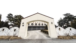 Un bâtiment doté d’une arche centrale et d’une porte de garage.