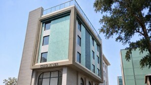 A modern building with a sign reading 'COSTA RIVER.' - Hotel Costa River (Varanasi)