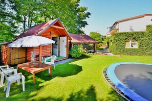 Relax in this charming cabin surrounded by a well-maintained lawn and a swimming pool.