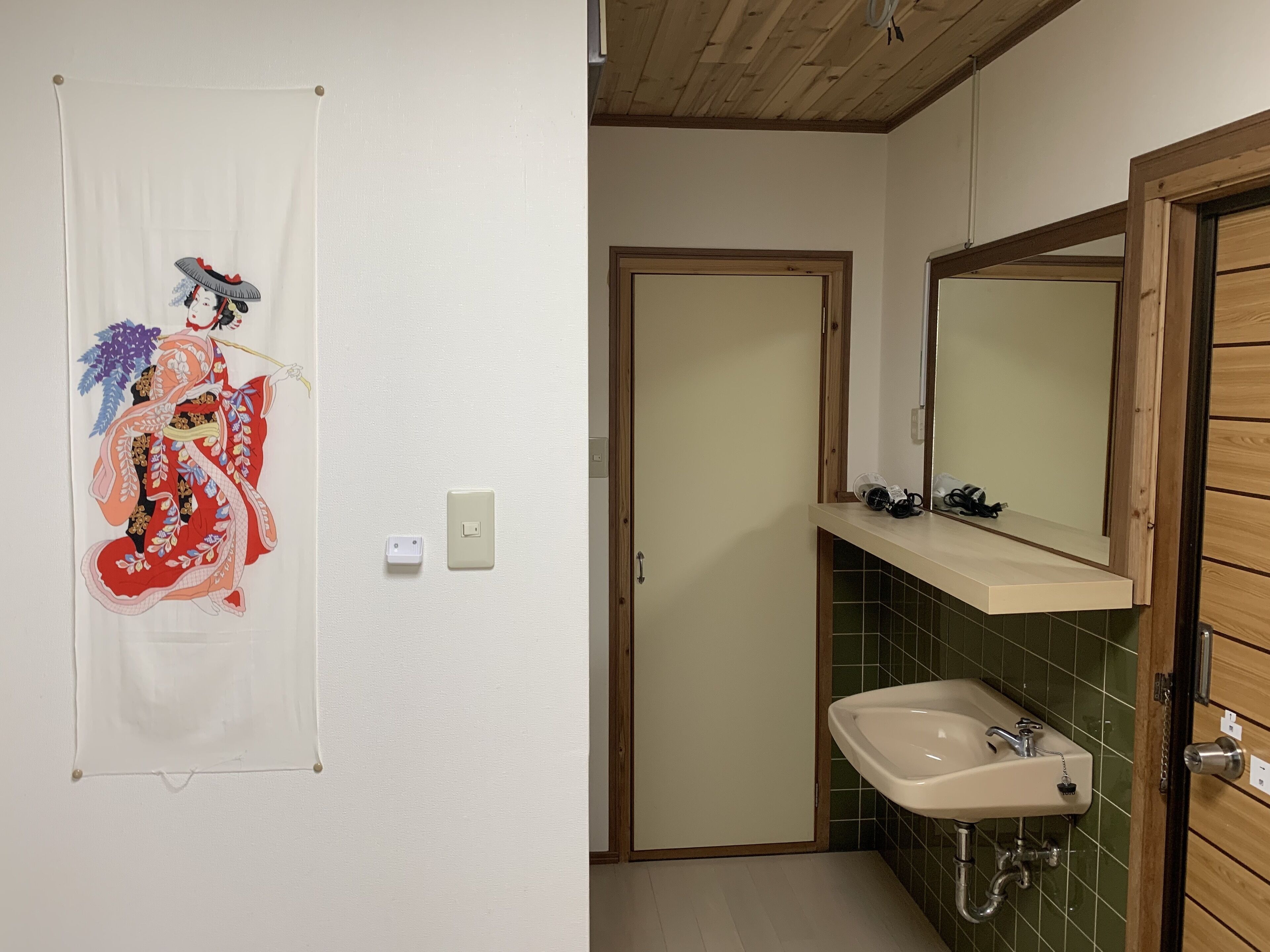 A traditional Japanese room with tatami flooring, a shoji screen, and a sliding door.
