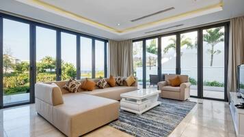 4 Bedroom Deluxe Villa, Partial Sea View | Living room | 40-inch flat-screen TV with digital channels