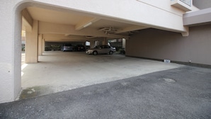 A parking garage with a car parked under an overhang.