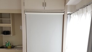 A compact kitchen with a refrigerator, a sink, and a countertop. - Fukuoka Story I (Fukuoka)