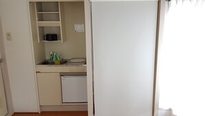 A compact kitchen with a refrigerator, a sink, and a microwave. - Fukuoka Story I (Fukuoka)