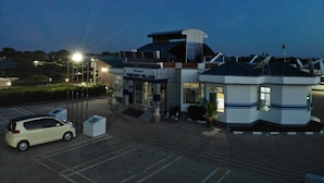 A modern building with a sign reading "Welcome to Fantasy Village." - Fantasy Village Hotel (Dodoma)