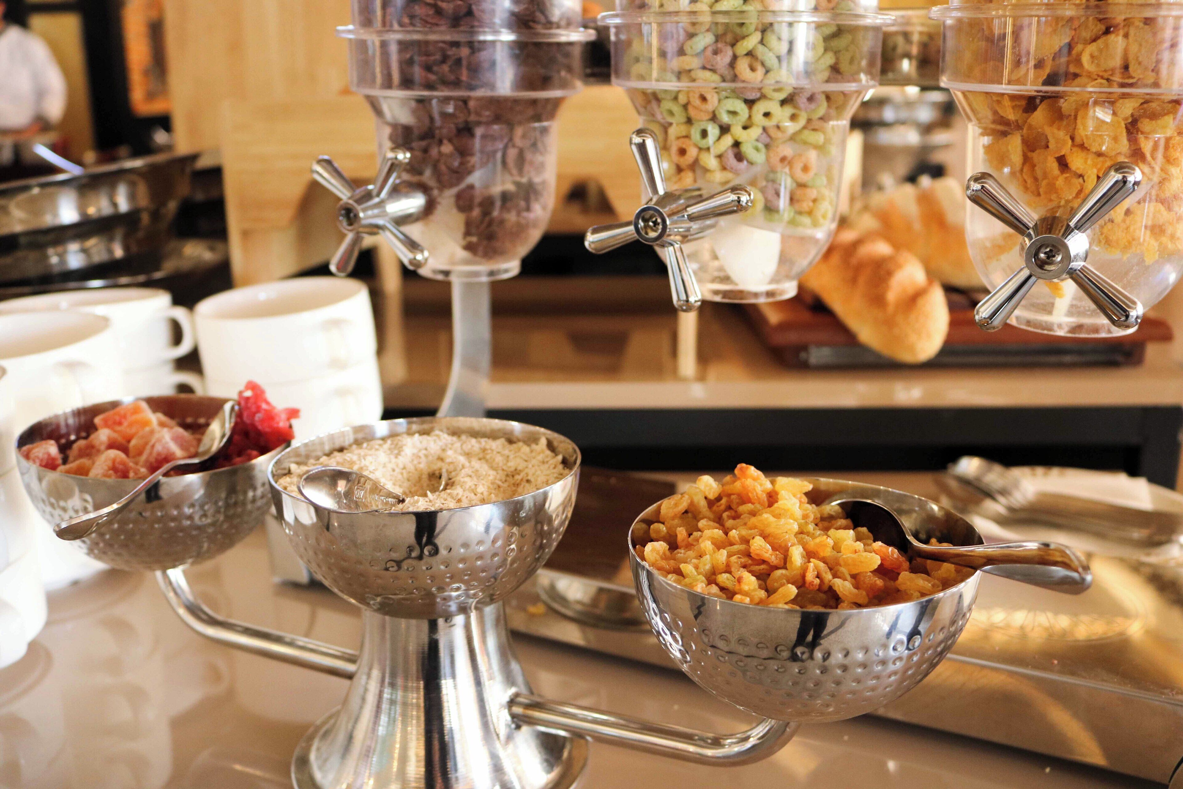 Una mesa de buffet con distintos recipientes y utensilios para servir.
