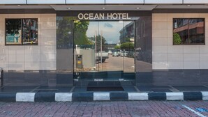 The entrance to the Ocean Hotel with a modern glass facade and a clear view of the street outside. - Capital O 89538 Ocean Hotel (Labuan)