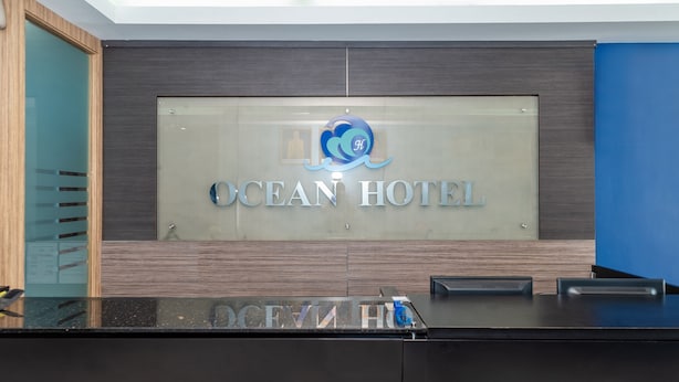 A reception desk with a sign that reads "OCEAN HOTEL". - Capital O 89538 Ocean Hotel (Labuan)