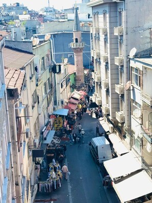 A narrow street lined with multi-story buildings, some with balconies and satellite dishes. - Red White Hotel (Istanbul)