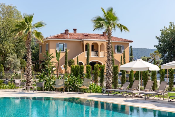 Seasonal outdoor pool, open 10:00 AM to 8:00 PM, pool umbrellas
