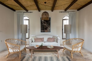 Deluxe Suite | Living area | 40-inch LED TV with satellite channels, TV