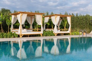 Seasonal outdoor pool, open 10:00 AM to 8:00 PM, pool umbrellas
