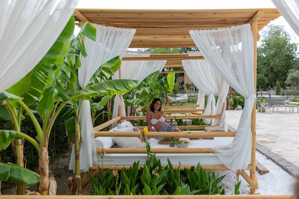 Seasonal outdoor pool, open 10:00 AM to 8:00 PM, pool umbrellas