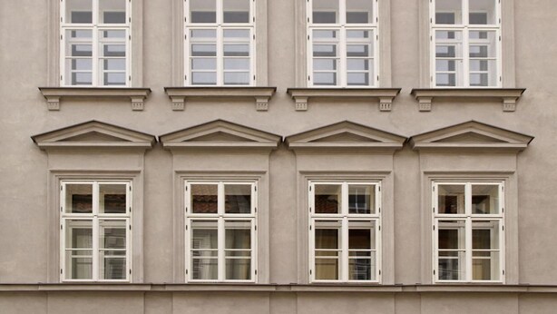 A building facade with six windows, each with a white frame and divided panes. - Teytz Apartments (Prague)