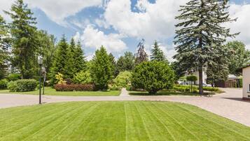 A well-maintained lawn with a pathway leading to a building.