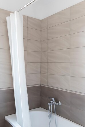 Separate tub and shower, rainfall showerhead, free toiletries