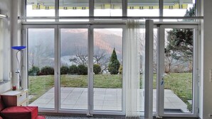 A room with a large sliding glass door leading to a patio.