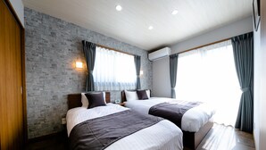 A modern hotel room with two beds, a brick-patterned wall, and large windows with curtains. - Oriya Mt.Fuji -Enishi- (Fujikawaguchiko)