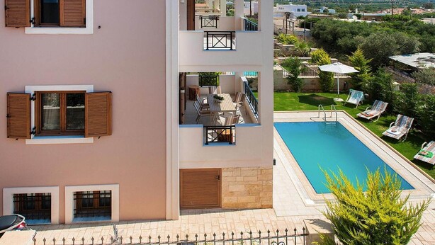 A multi-story building with a pool, outdoor seating, and a view of the surrounding area. - Adele Villa with Pool & Terrace (Adele)