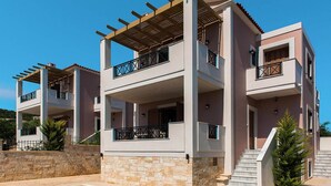 A multi-story residential building with balconies, a swimming pool, and stone walls. - Adele Villa with Pool & Terrace (Adele)