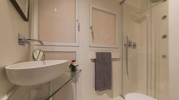 Shower, hair dryer, towels, toilet paper