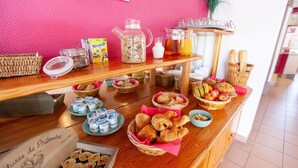 A breakfast buffet with various food items and beverages.