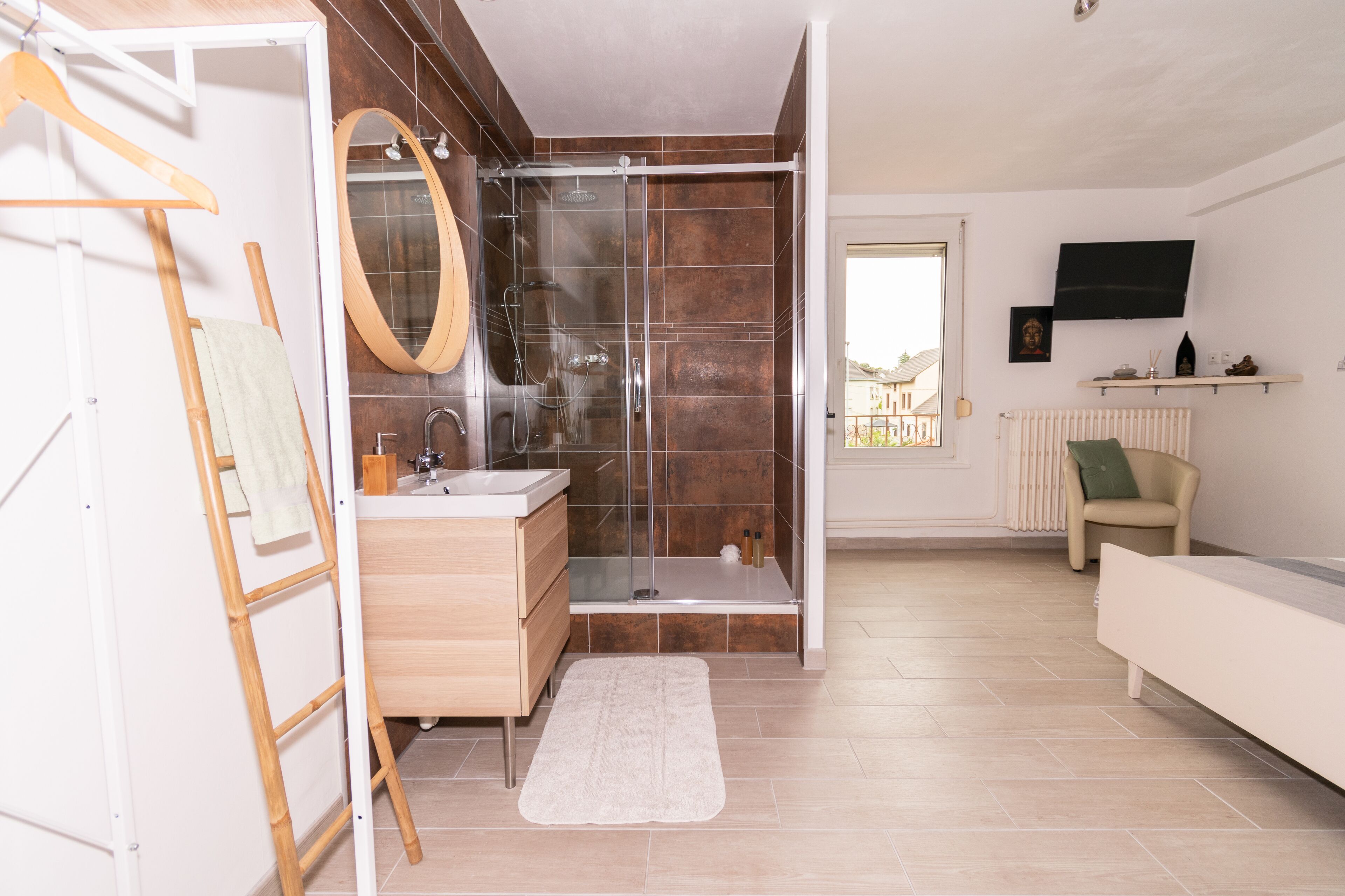 A modern bathroom with a shower, sink, and vanity.
