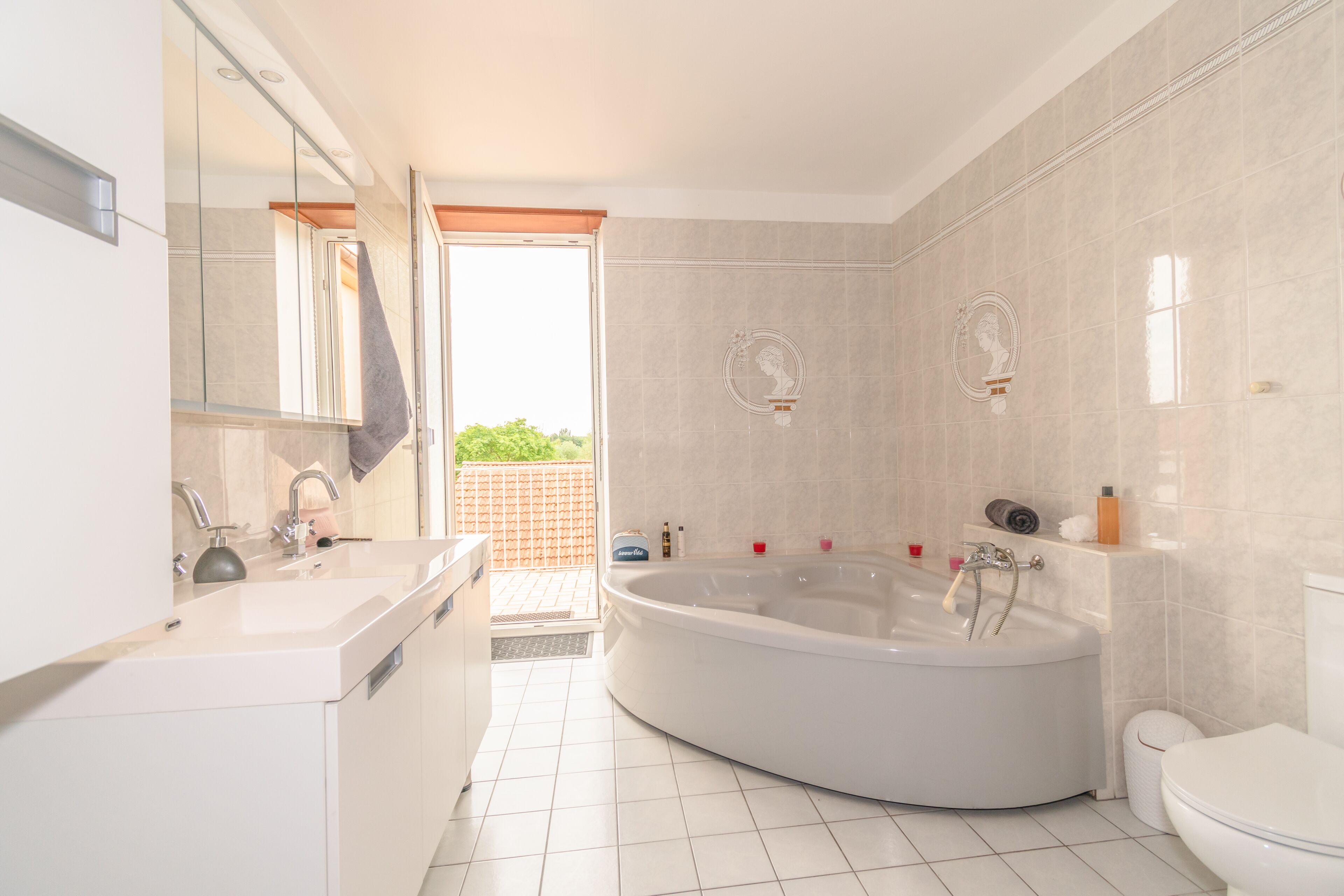 A modern bathroom with a freestanding bathtub, a toilet, and a sink.