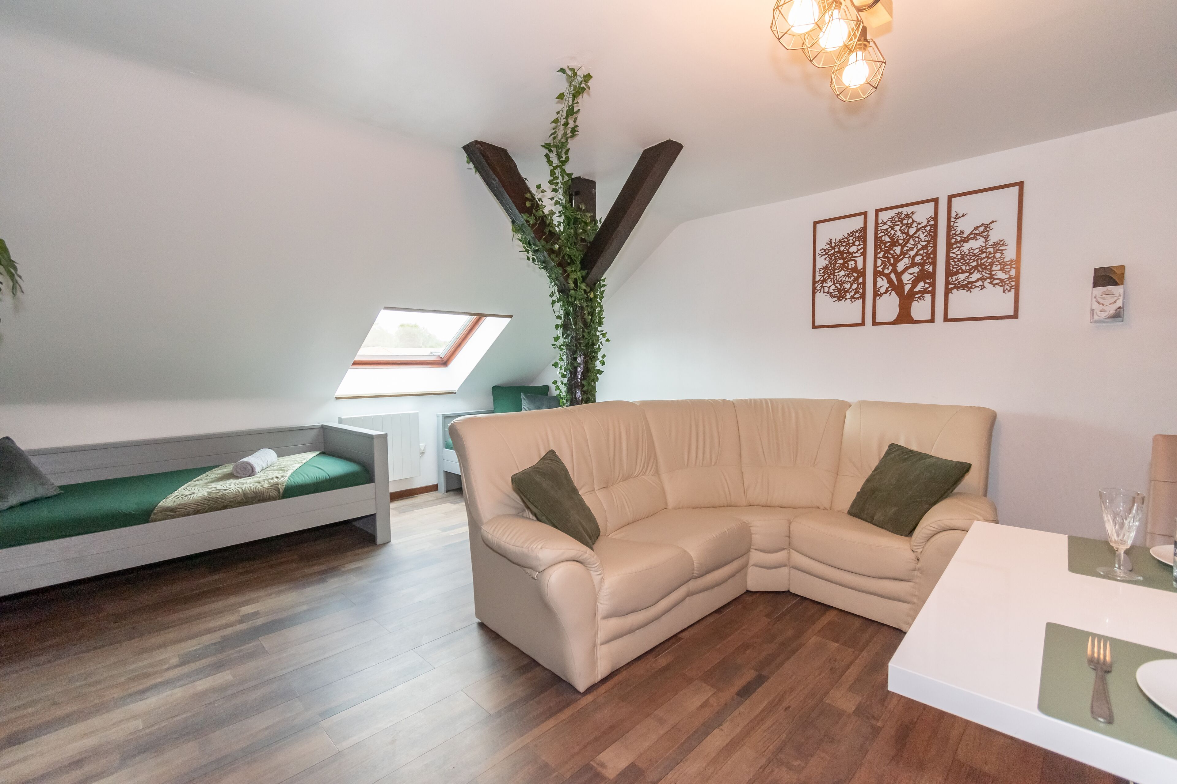 Un salon moderne avec un canapé, une petite table et une plante.