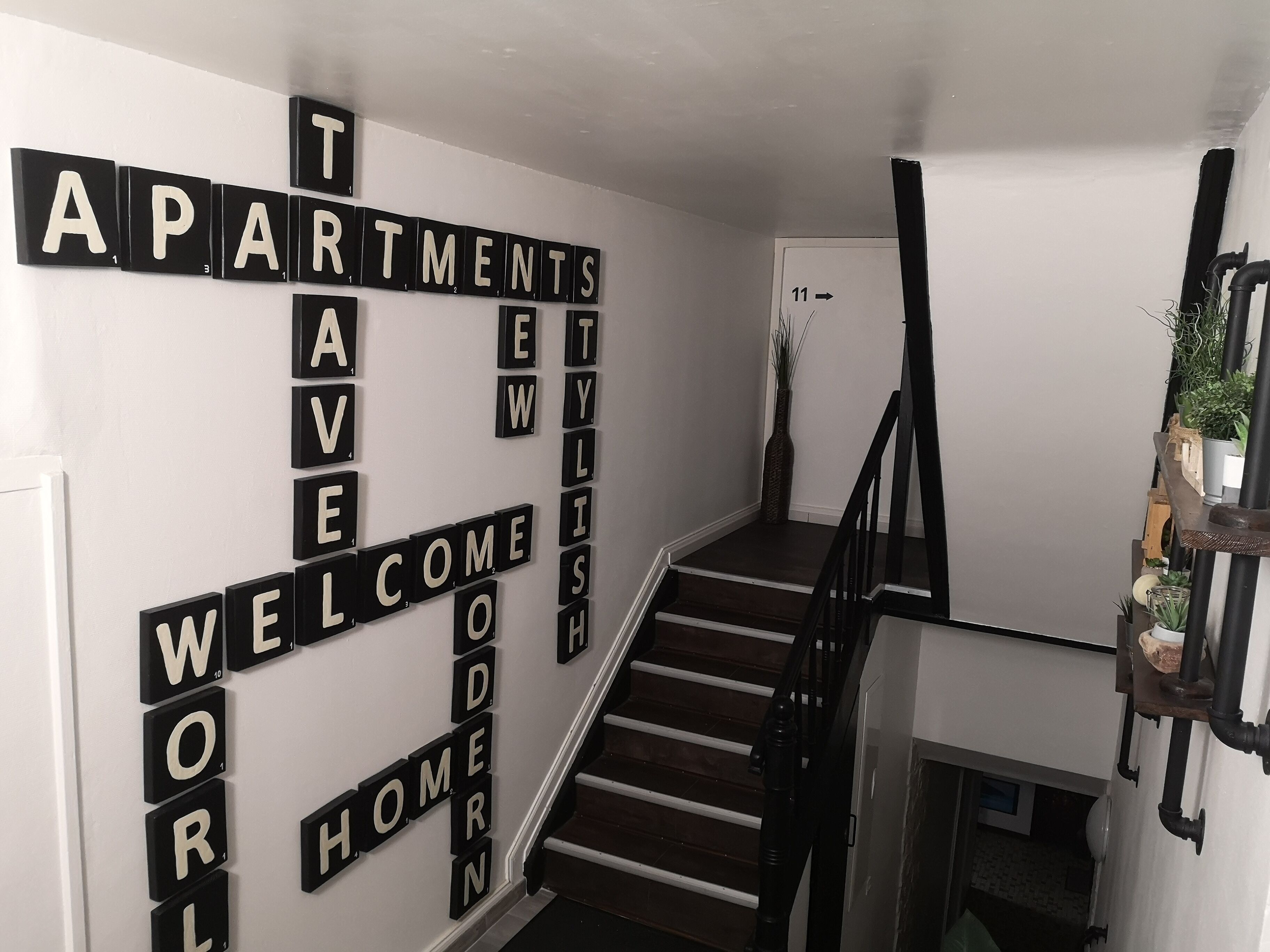 A staircase with a sign reading "Welcome to Apartments."
