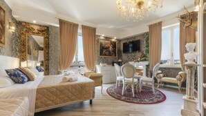 A luxurious bedroom with a large bed, a desk, and a television. - Olympus Verona Relais (Verona)