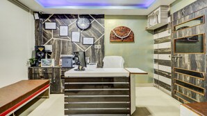 A modern office with a desk, computer, and framed certificates on the wall. - Treebo Dreamland Guest House (Barasat)