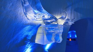 A large, clear ice sculpture with a reflective surface, likely part of an exhibit or decoration. - Hunderfossen Snøhotell (Lillehammer)