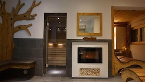 A modern interior with a fireplace, wooden decor, and a visible staircase. - Apartment in Wildschönau by Schatzberg Lift (Wildschönau)