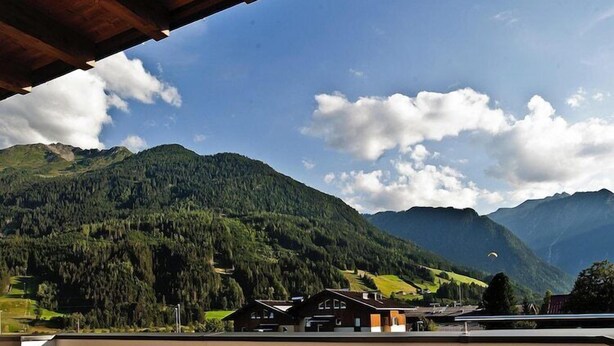 A mountainous landscape with a clear sky and a few clouds.