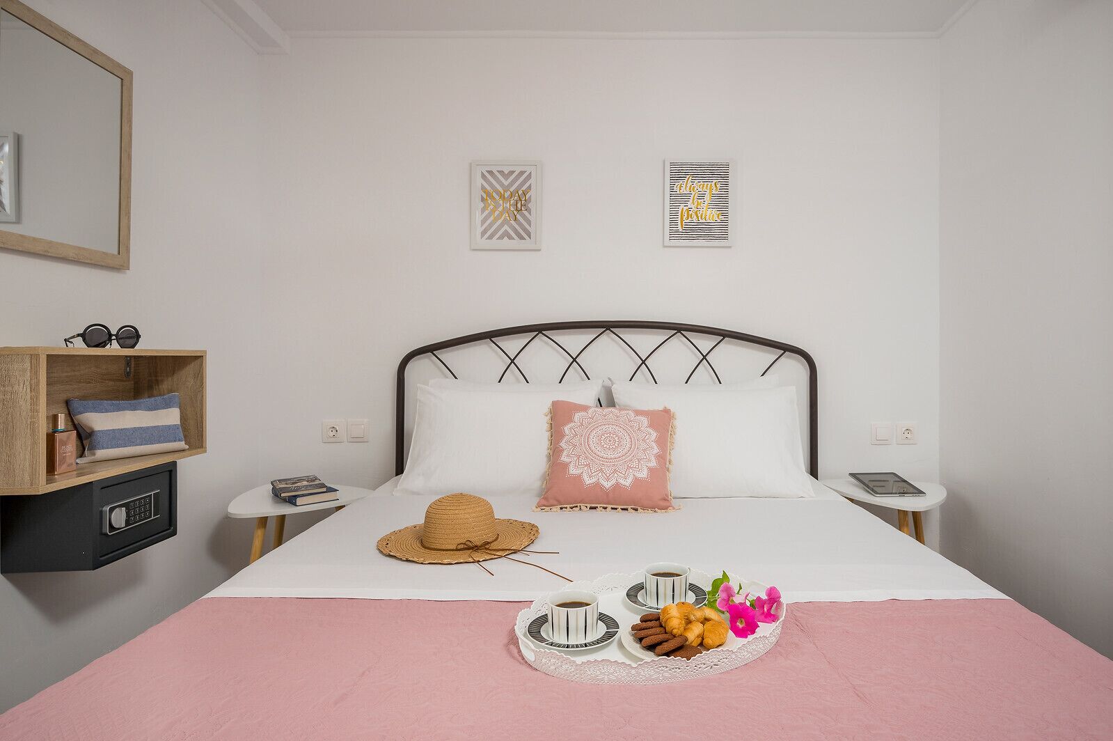 A neatly arranged bedroom with a bed, bedside tables, a small shelf, and a bedside lamp.