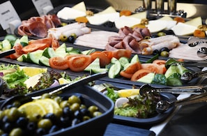 A buffet with various meats, cheeses, and fresh vegetables. - Ibis Tbilisi Stadium (Tbilisi)