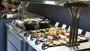 A buffet with various food items including salads, cheeses, and meats. - Ibis Tbilisi Stadium (Tbilisi)