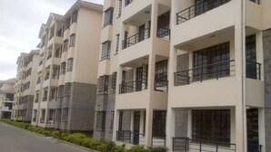 A row of modern multi-story residential buildings with balconies and large windows. - Memo's Homestay (Mlolongo)